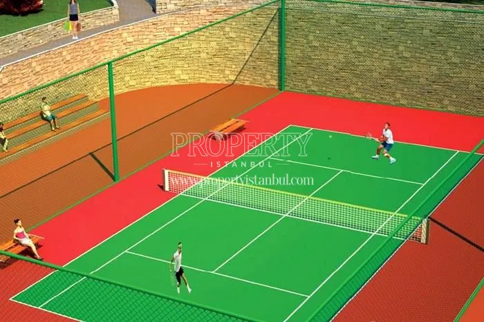 The people playing tennis on the tennis court in the Yakacik Bagbahce Evleri compound