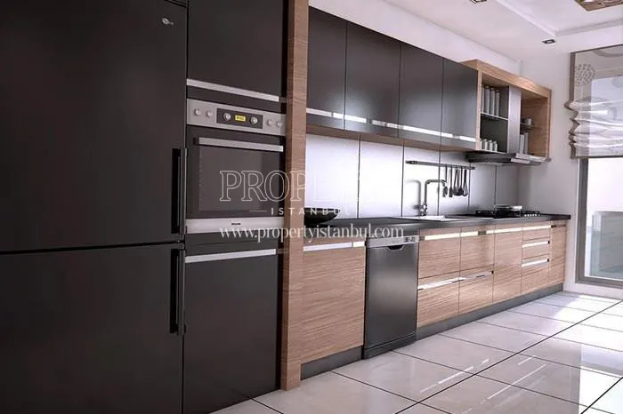 The kitchen with black and brown kitchen cabinets in Yasemin Evleri