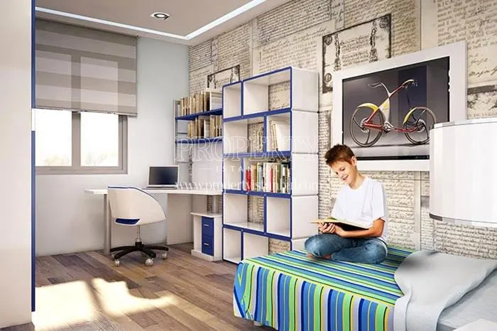 The boy studying in his bedroom in Yasemin Evleri