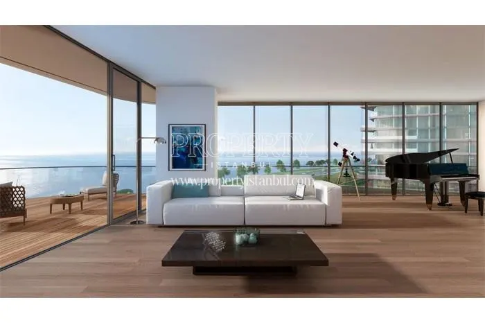 White sofa and piano in one of the living rooms with a sea view in Yedi Mavi
