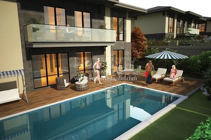 The family swimming in their villa's pool in Yonca Villapark