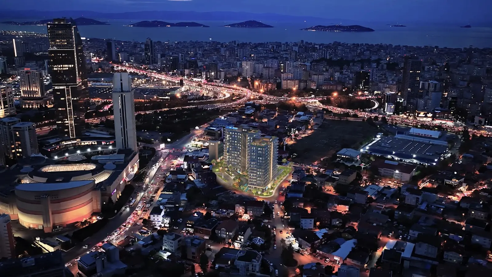 Aerial view of Algun Prime Atasehir at night, with the Princes' Islands behind