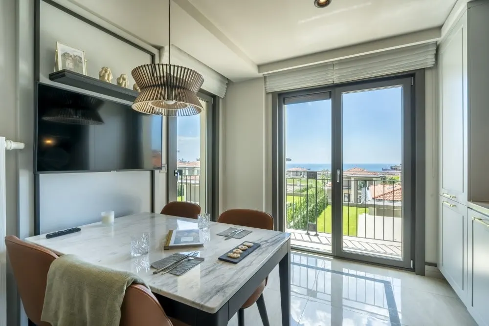 Dining table by the balcony door in the Deniz Istanbul Sedef Konaklari show apartment