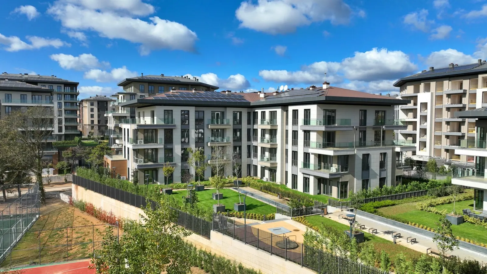 Apartment blocks and gardens of Emlak Konut Cinarkoy Evleri seen from above