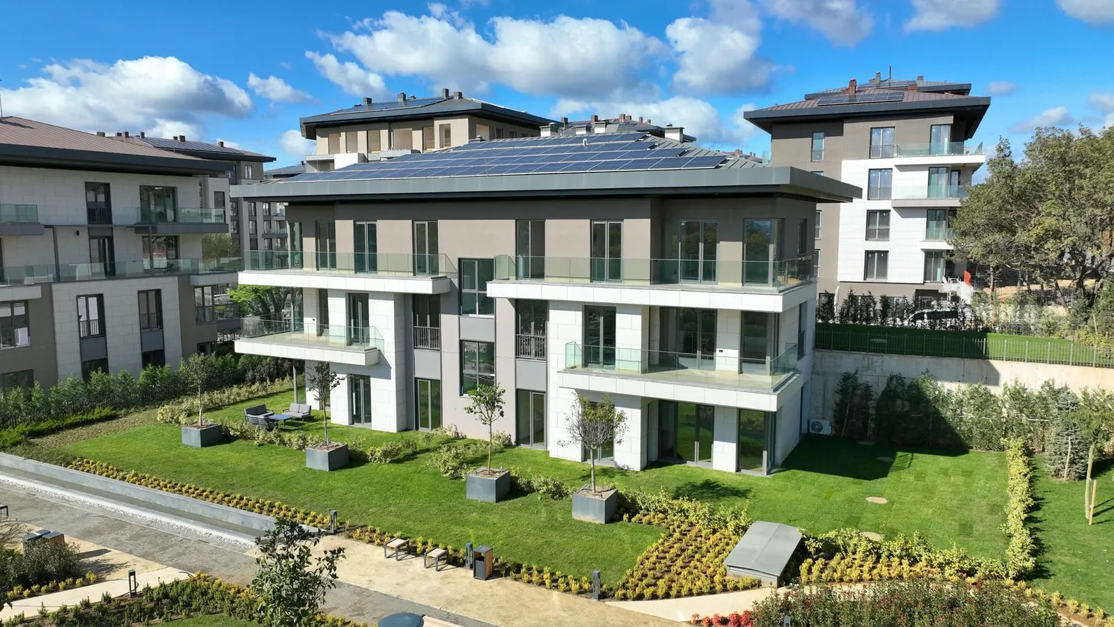 Low-rise block and lawns at Emlak Konut Cinarkoy Evleri