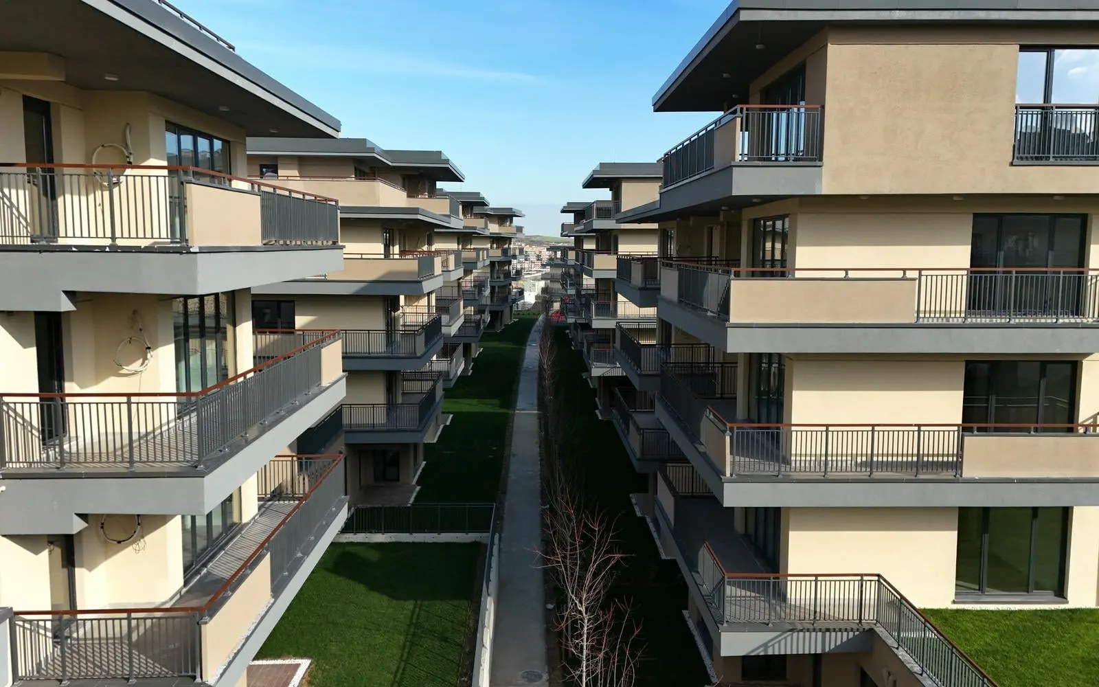 Row of blocks along a garden path at Emlak Konut Vadi Evleri 2. Etap