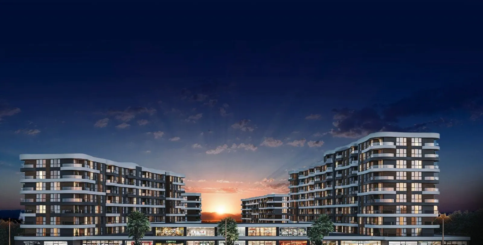Inlight Yenisehir blocks and street-level shops at dusk