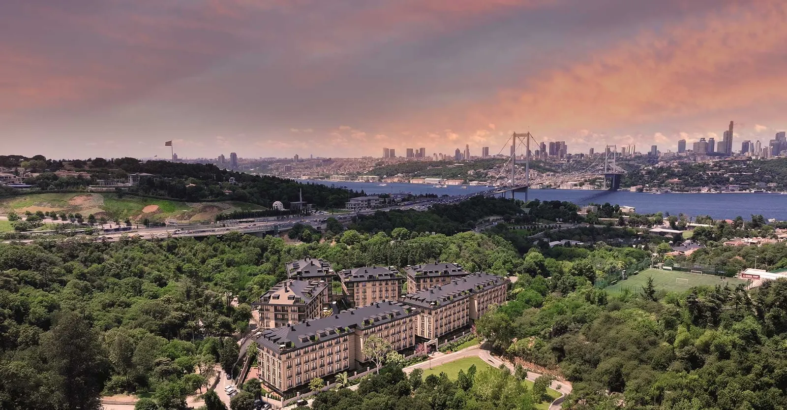 Aerial view of the Palace Istanbul Beylerbeyi blocks in woodland, with the 15 July Martyrs Bridge behind